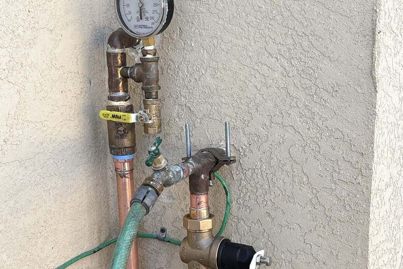 Copper pressure regulator and shutoff valve assembly repaired on an exterior wall