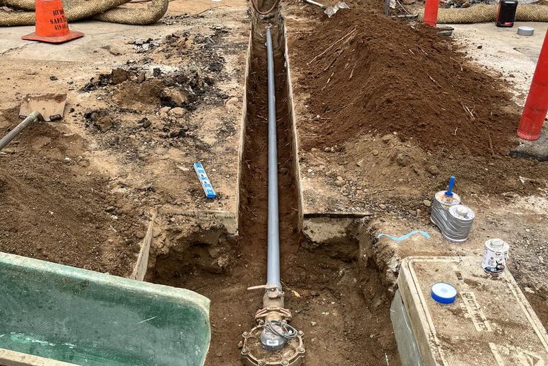 New water service line and meter box set in an open trench during new construction