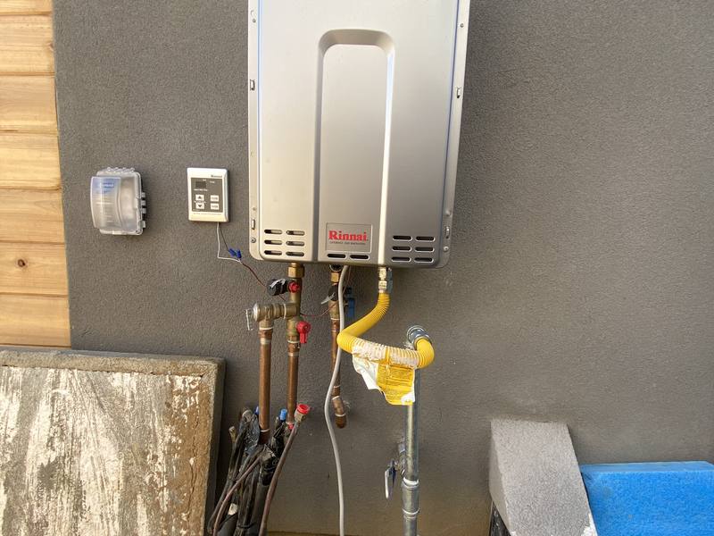 Tankless water heater installed with new gas and water connections