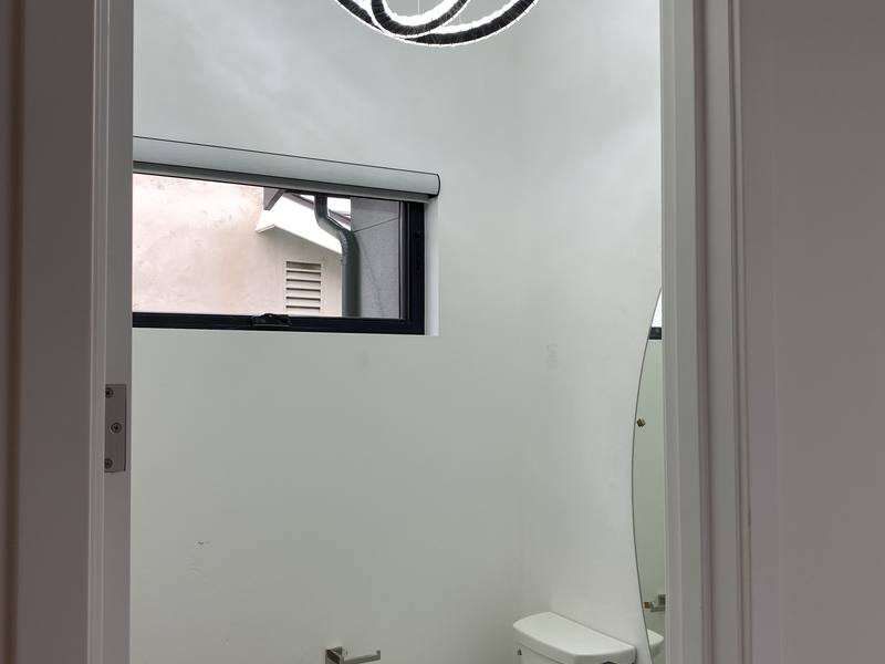 Remodeled bathroom with a new toilet and finished walls