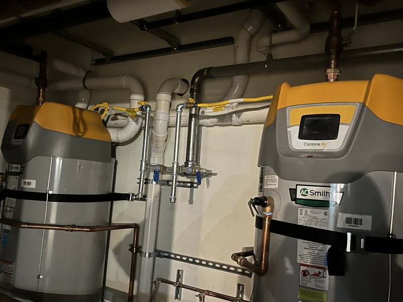 Commercial water heaters and copper manifold in a mechanical room