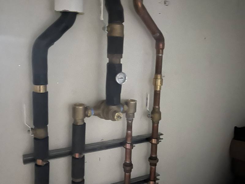 Copper water manifold with brass shutoff valves and pressure gauge