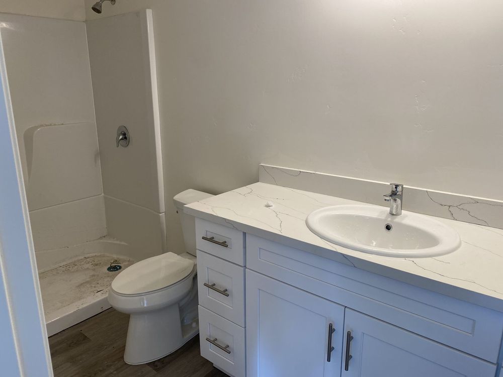 Finished bathroom with a new vanity, sink and toilet installed