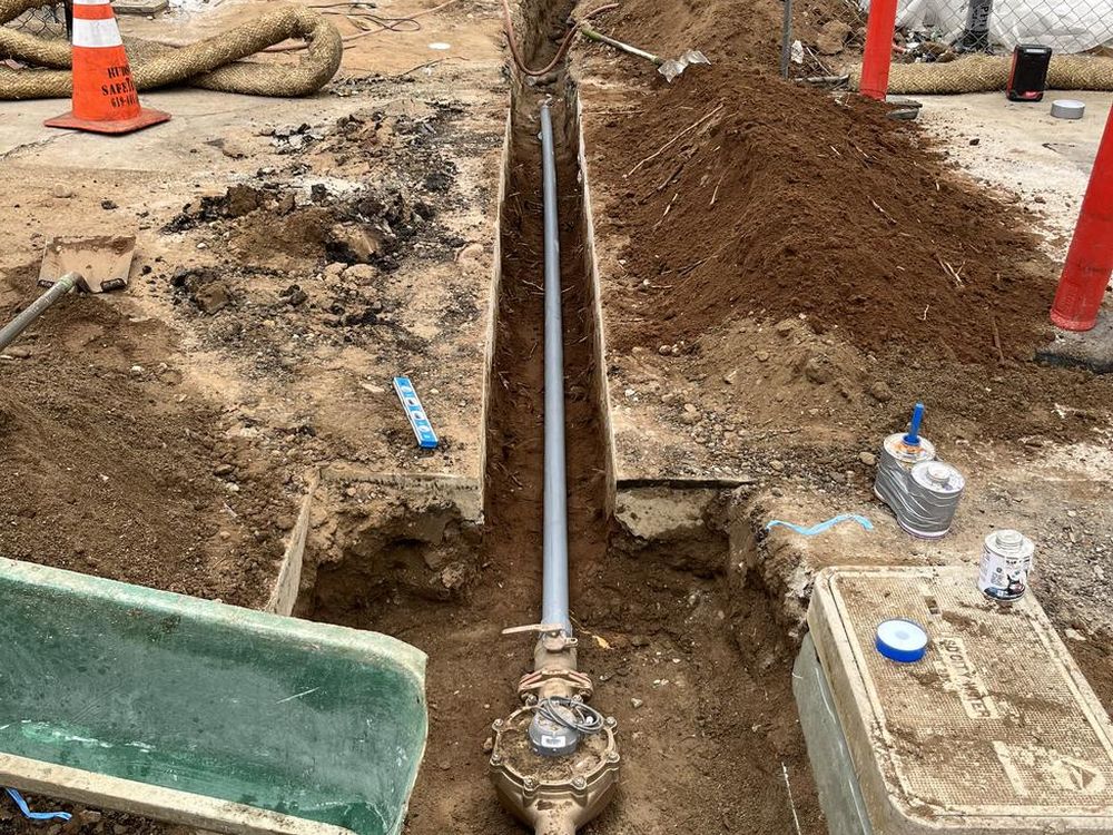 New water service line and meter box set in an open trench during new construction
