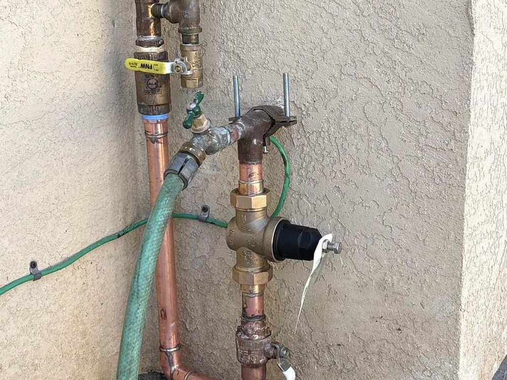 Copper pressure regulator and shutoff valve assembly repaired on an exterior wall