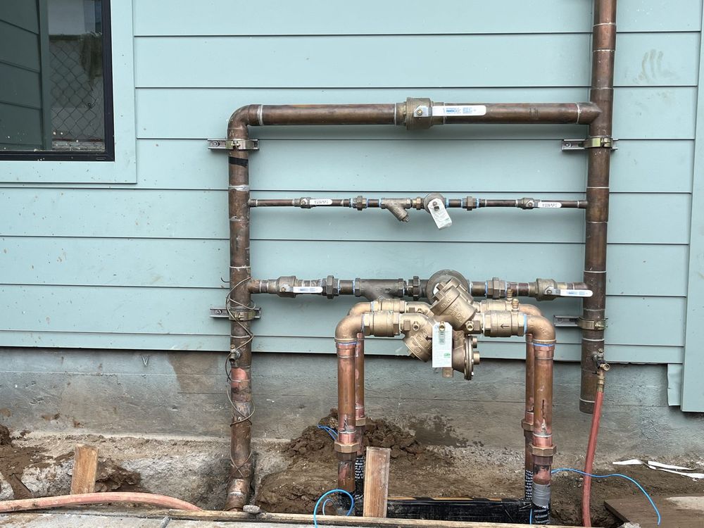 Copper repipe manifold with new shutoff valves installed on the exterior of a San Diego home